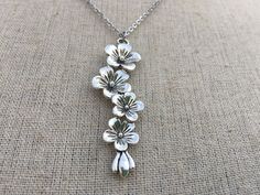 "This is so unique and pretty! Elongated flower pendant necklace. It has incredible detail and design. The perfect necklace for any botanical lover. It would make a very lovely gift. The pendant is made from allergy free plated silver and measures 2 1/4\" long by 1/2\" wide. It hangs from a simple 18\" stainless steel necklace chain with a lobster clasp. I have matching earrings in my shop, if you would like the whole set. Here is the link https://etsy.me/2RL7mtu Thanks for stopping by! Please t Bohemian Flower-shaped Nickel-free Necklace, Bohemian Flower-shaped Nickel Free Necklace, Silver Necklaces With Flower Charm For Spring, Silver Necklace With Flower Charm For Spring, Spring Birth Flower Jewelry, Flower Shaped Necklace For Spring Gift, Spring Flower Pendant Jewelry Gift, Nickel Free Flower Shaped Necklace, Spring Flower Charm Necklace For Gift