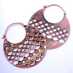 two large metal hoops with intricate designs on them