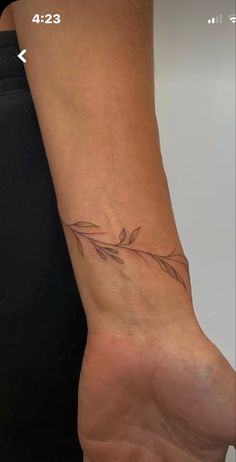 a woman's foot with a small tattoo on the left side of her arm