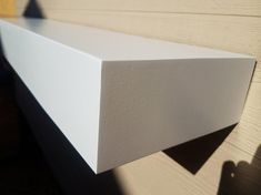 a white shelf sitting on top of a wooden floor