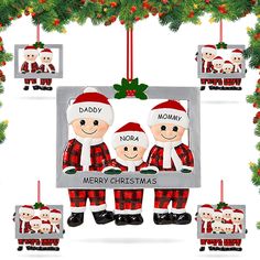 a christmas ornament with three people in red and white outfits, hanging from a tree