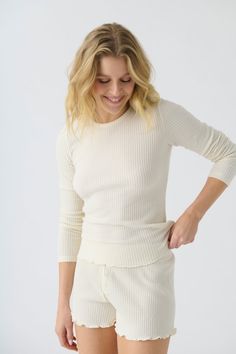 Women's ivory rib knit fitted long sleeve top & curly-edge hem Spring Textured Tops For Loungewear, Soft Textured Long Sleeve Tops For Spring, Textured Tops For Spring Loungewear, Spring Textured Loungewear Tops, Fine Knit Long Sleeve Top For Spring, Long Sleeve Solid Knit Top For Layering, Solid Long Sleeve Knit Top For Layering, Ribbed Stretch Long Sleeve Top For Loungewear, Textured Knit Top For Loungewear