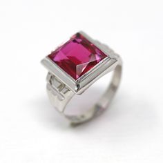 "Classic vintage circa 1930s Art Deco era 10k white gold created ruby ring! This beautiful statement ring features a rectangular faceted 6.46 carat created ruby, that is securely bezel set. There are classic designs on the shoulders, and the shank is free of design. A stunning piece of fine Art Deco era jewelry, featuring July's birthstone, design patented in 1932! *Sale - price reduced from $475 USD to $445 USD.  ERA - Circa 1930s - Art Deco METAL / MATERIAL - 10k white gold, created ruby (approx. 6.46 CT) (Contains essentially the same chemical composition & properties as its natural counterpart, but created by man.) MARKINGS / HISTORY - Inside of band is marked \"K PAT. NO 1862710\" https://patents.google.com/patent/US1862710 CONDITION - Good vintage condition. White gold metal has been Art Deco Metal, 6 July, Vintage Sapphire Ring, July Birthstone Ring, Vintage Cocktail Ring, 1930s Art, July Birthstone Jewelry, Sparkling Rings, Gold Art Deco