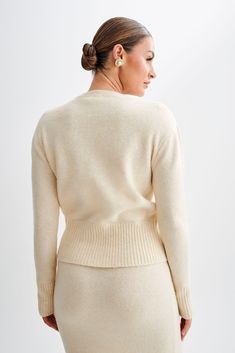 All cozied up.The GENEVIEVE Oversized Knit Cardigan epitomises cozy chic with its luxurious design and effortless style. Featuring a classic round neckline and a functional centre front closure, this cardigan offers both timeless elegance and practicality. The ribbed neckline, hem, and cuffs add texture and detail, while the long sleeves provide warmth and comfort. Crafted from a soft and high-quality knit fabric, it envelops you in comfort while exuding sophistication. Whether matched with the Elegant Beige Soft Knit Cardigan, Elegant Fine Knit Loungewear Sweater, Elegant Fine Knit Sweater For Loungewear, Chic Cream Crew Neck Cardigan, Chic Crew Neck Cardigan, Elegant Soft Knit Long Sleeve Cardigan, Elegant Soft Knit Cardigan For Daywear, Winter Chic Crew Neck Cardigan, Chic Crew Neck Winter Cardigan