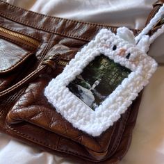 a purse with a photo hanging from it