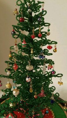 a green christmas tree with ornaments on it