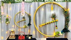 the table is set up for an event with peacocks and flowers on it, along with other decorations