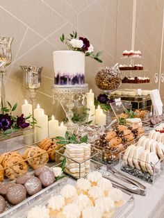 a table topped with lots of different types of desserts