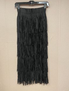 Carrying a luxurious look and feel, this fringe midi skirt is fun, trendy and oh so flattering. Crafted with an elastic waistband and large fringes from a blend of 65% cotton and 34% polyester, this piece exudes a tasteful and elegant vibe. Perfect for all sizes, from 2 to 10, this skirt will add freshness and brightness to any wardrobe. Chic Tassel Skirt For Night Out, Chic Skirt With Tassels For Night Out, Chic Fringe Skirt, Chic Fringe Skirt For Night Out, Black Bottoms With Tassels For Night Out, Long Fringed Skirt For Summer, Spring Black Bottoms With Tassels, Long Summer Skirt With Fringe, Long Fringe Skirt For Summer