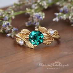 Nature Inspired Leaf Emerald Ring Art Deco Emerald Pearl Gold Ring Vintage Leaf Engagement Ring Birthstone Anniversary Promise Gift For Her ※Setting in Akoya pearl: https://www.etsy.com/listing/1342174889/natural-pearl-diamondmoissanite-ring ※Setting in Moonstone: https://www.etsy.com/listing/1251219218/vintage-moonstone-engagement-ring-leaf ▶ Ring Details: ※Metal: 14K or 18K Solid Gold (Rose, White, or Yellow), Silver ▶Engagement Ring： ※Center Stone: Lab Created Emerald ※Shape&Quality: 6mm, Rou Gold Emerald Ring With Nature-inspired Design, Gold Nature-inspired Emerald Ring As A Gift, Nature-inspired Gold Emerald Ring As A Gift, Nature-inspired Gold Emerald Ring As Gift, Nature-inspired Gold Emerald Ring For Gift, Nature-inspired Gold Emerald Ring Gift, Gold Flower Ring With Emerald, Gold Flower Ring With May Birthstone, Nature-inspired Emerald Ring For May Birthstone Gift