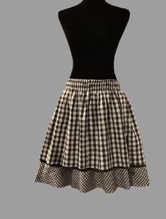 "Vintage 1950's Black and White Checkered Two Layer Skirt. Condition: The skirt is in great condition. Please Note:  There is not a size, care or fabric tag on the skirt. Please use the measurements below to ensure proper fit. Waist:  26 1/2 inches unstretched  36 inches stretched to maximum Length: 23 inches Fabric: Although I can not be certain, I believe the skirt is 100% cotton. Returns: ❤️  We gladly accept returns. We kindly ask that the item is returned in the condition in which it was re Black Vintage Ruffled Skirt, Black Vintage Tiered Skirt, Vintage Black Skirted Bottoms, Vintage Black Gathered Skirt, Vintage Black Lined Skirt, Vintage Black Flared Skirt, Vintage Black Petticoat, Retro Black Mini Skirt With Lining, Retro Black Long Skirt