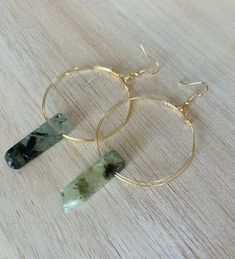 These are beautiful, earthy, minimalistic crystal hoops made from natural citrine or natural green agate and high quality tarnish resistant wire. Each hoop is hand wrapped with a single piece of wire with a natural Citrine or Green Agate Crystal added which makes every pair one of a kind and unique.  Ear hooks are gold plated. Size and shape of crystals will be unique to each pair of earrings. Adjustable Gemstone Hoop Jewelry, Minimalist Gemstone Hoop Jewelry, Gold Jewelry With Natural Moss Agate Stones, Modern Wire Wrapped Round Hoop Earrings, Modern Wire-wrapped Round Hoop Earrings, Minimalist Natural Stone Earrings, Minimalist Green Agate Jewelry, Handmade Hoop Jade Jewelry, Hoop Earrings With Natural Stones