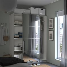 a bedroom with a mirrored closet door and shoes on the floor