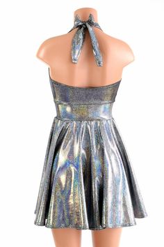 "This item is made to order, please read all the way through the listing before purchasing! This flowy dress is made of beautiful silver holographic spandex. The halter top is darted and ties behind the neck, the hemline is circle cut. Length: 17\" measured from the waist to the hemline. We can create this dress from any other fabric in our shop, just ask! Womens Sizing (See below for instructions on where measurements should be taken) XXS: Bust 29\"-30\" / Waist 22\"-23\" / Hips 30\"-32\" Extra Fitted Sleeveless Shiny Dress, Fitted Metallic Backless Dress, Metallic Fitted Backless Dress, Metallic Backless Dress, Metallic Fitted Halter Neck Dress, Silver Halter Neck Dress For Summer, Silver Halter Neck Summer Dress, Metallic Sleeveless Shiny Dress, Metallic Shiny Disco Dress