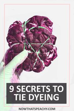 a hand holding up a purple flower with the words 9 secrets to tie dyeing