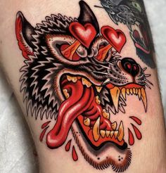 a close up of a person's arm with tattoos on it and an animal