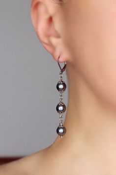 Beautiful long pearl earrings with dark gray finest quality European crystal pearl coated 8 mm beads, stainless steel flower shape bead caps, tiny steel beads-separators and stainless steel lever back earring hooks. Earring hooks are from nickel free and lead free metal. *The total lenght of earrings is about 67 mm including earring hooks. Other earrings of my shop you can see here: https://www.etsy.com/shop/NaTavelli?section_id=13757927 Thanks for visit. Dangle Crystal Earrings, Simple Bead Earrings, Pearl Bead Earrings, Crystal Bead Earrings, Grey Pearl Earrings, Diy Earrings Easy, Long Pearl Earrings, Earring Beads, Jewelry Making Earrings