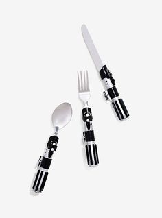 three forks and two spoons made to look like skeleton faces