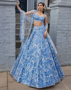 This lehenga set features powder blue three-dimensional floral embroidery, highlighted with crystals, pearls, and sequins on an ivory base. The waist of the blouse is scalloped and shows crystal drops. It is paired with a four-sided embroidered dupatta.From Seema Gujral's For the love of London collection. DELIVERY TIMEPlease allow 8-12 weeks for your outfit to arrive. FABRIC DETAILSNet Professional cleaning only. Pale Blue Lehenga, Pretty Indian Outfits, Blue Sequined Sets For Reception, Blue Sequined Sharara For Reception, Blue Sharara With Sequins For Reception, Traditional Hand Embellished Blue Choli, Blue Hand Embellished Choli For Reception, Blue Hand Embellished Sharara For Reception, Glamorous Blue Embellished Sets