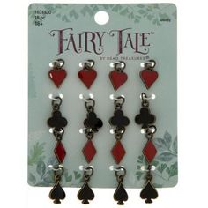 four pairs of red and black earrings with hearts on each earring, in front of a card board