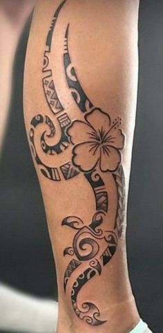 a woman's leg with a tattoo on it and flowers in the middle of her legs