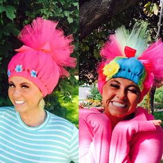 two women with pink hair and blue eyes are smiling at the camera while wearing matching headgear