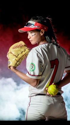 a woman in a baseball uniform holding a catchers mitt with clouds behind her