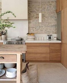 a kitchen with wooden cabinets and an island in the middle, along with a basket on the floor