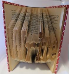 an open book with pages folded in the shape of books