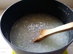 a wooden spoon in a pot filled with water