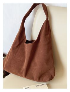 Carry your essentials in style with the Elena Handbags Soft Suede Shoulder Bag. Made of luxurious suede, this bag is both soft and durable. With its roomy interior and adjustable strap, it's perfect for everyday use. Upgrade your handbag game with Elena Handbags. Material: High Quality Suede PU Leather Size approximately 9.8"H x 15.7"W x 5.5"D Designer Style ID: 8759 Brown Suede Hobo Bag For Shopping, Versatile Suede Hobo Tote Bag, Everyday Suede Hobo Bag, Rectangular Shoulder Bag With Soft Interior For Everyday, Brown Hobo Bag With Suede Lining For Shopping, Versatile Everyday Suede Shoulder Bag, Versatile Suede Tote Hobo Bag, Versatile Suede Shoulder Bag For Everyday Use, Large Capacity Suede Shoulder Bag For Everyday Use