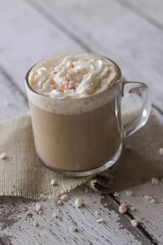 a cup of hot chocolate with whipped cream and sprinkles