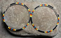 Here's a pair of Black with Native Colors hoop earrings that are lightweight and comfortable to wear all day long. Made with high quality glass Delica Beads, beaded one bead at a time.  Love and passion goes into making my jewelry. This process requires focus, patience and dedication. Each bead is 16th of an inch and can take hours to complete a project. These hoops are 3" wide around. They would be a great addition to your wardrobe.  You will receive many compliments. These hoops would be a gre Seed Bead Hoop Earrings, Bead Hoop Earrings, Homemade Jewelry, Delica Beads, Large Hoop Earrings, Beaded Hoop Earrings, Beaded Hoops, Beaded Jewelry Diy, Beaded Earrings