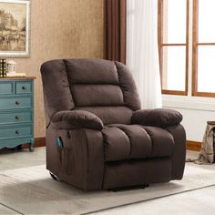 a brown recliner sitting on top of a rug in a living room next to a window