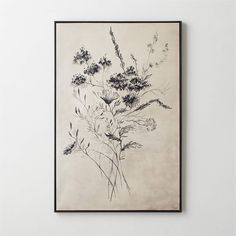 a black and white painting on a wall above a framed art piece with flowers in it