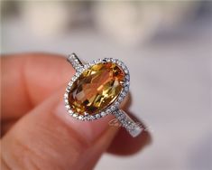 Gorgeous 8*12 mm  oval Citrine ring, made with 925 sterling silver, plated with white gold.Main Stone: 8*12 mm Natural CitrineSide Stone: CZNeed other size please contact.CS0100 Oval Orange Rings With Accent Stones, Orange Oval Rings With Accent Stones, Yellow Oval Topaz Ring With Halo Setting, Oval Orange Topaz Ring With Center Stone, Orange Oval Topaz Rings, Oval Orange Topaz Gemstone Ring, Yellow Citrine Engagement Ring, Yellow Gemstone Jewelry, Citrine Engagement Ring