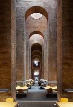 the inside of a building with tables and benches