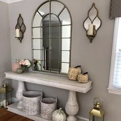 a room with a mirror, stools and other items on the table in front of it