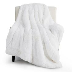 a white blanket sitting on top of a chair