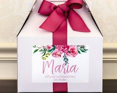 a white box with pink flowers and a red ribbon on it that says, maria will give you another home for valentine's day