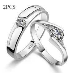 two white gold wedding rings with diamonds on each side and one diamond in the middle