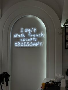 a neon sign that reads i don't speak french except croissant