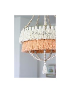 a chandelier with tassels hanging from it's sides and words on the side