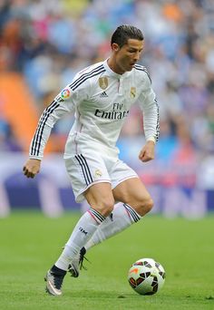 the soccer player is about to kick the ball in his team's match with real madrid