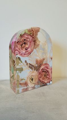 a glass box with flowers painted on it