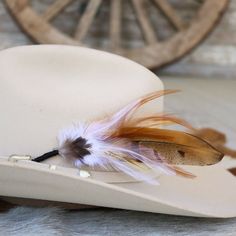 This handmade arrangement of feathers is the perfect way to set your hat apart from the rest. Simply tuck into the band of any hat. Made with a mix of pheasant tail and rooster feathers. Approximately 8 inches long, sizes may vary due to being made with natural materials.  Includes: 1 Handmade Arrangement of Feathers. How to use: Tuck into the hat band of any hat. *Each one will vary slightly due to being handmade. *Hat not included.  Natural Feathers * Approx. 8 inches - sizes may vary slightly Feathered Brimmed Felt Hat For Ranch, Brimmed Felt Hat With Feathers For Ranch, Ranch Brimmed Felt Hat With Feathers, Southwestern Feather Hat Band For Country Events, Curved Brim Hat Bands With Feathers For Western-themed Events, Western Hat Bands With Feathers For Rodeo, Western Wide Brim Top Hat With Feathers, Western Short Brim Felt Hat With Feathers, Western Felt Hat With Feathers And Short Brim