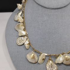 *Description: This is a white enamel over gold tone sea shell charm necklace with real or faux baroque pearls and 8mm faux pearls on the extension chain from the 1950s. This necklace has the same charms as a Napier necklace without the white enamel. I can not find another one like it. This is very similar to this Napier necklace with the same shape of clam and oyster shells but this necklace is unsigned. The pearls may be real baroque or may be faux. No matter which is accurate, it is a wonderfu Vintage Gold Shell Jewelry, Vintage Gold Shell, Vintage Shell Gold Jewelry, Vintage Pearl Jewelry With Lobster Clasp, Vintage Shell Shaped Jewelry, Vintage Mother Of Pearl Shell Jewelry, Shell Charm Necklace, Formal Earrings, Pearl Charm Necklace