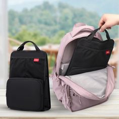 two backpacks sitting next to each other on a table