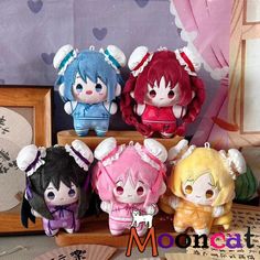 four small stuffed animals sitting on top of a wooden shelf