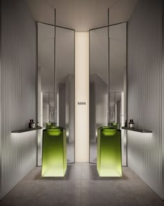 a bathroom with two sinks, mirrors and green counter tops in front of the mirror